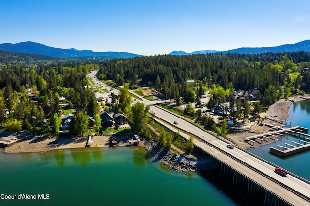 drone / aerial view featuring a water and mountain view