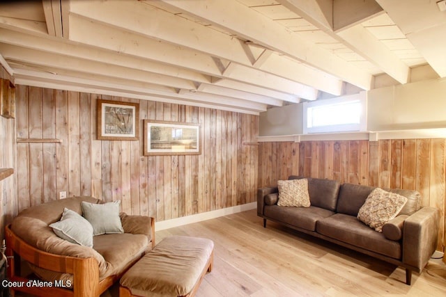 living room with light wood-type flooring, wooden walls, and beam ceiling