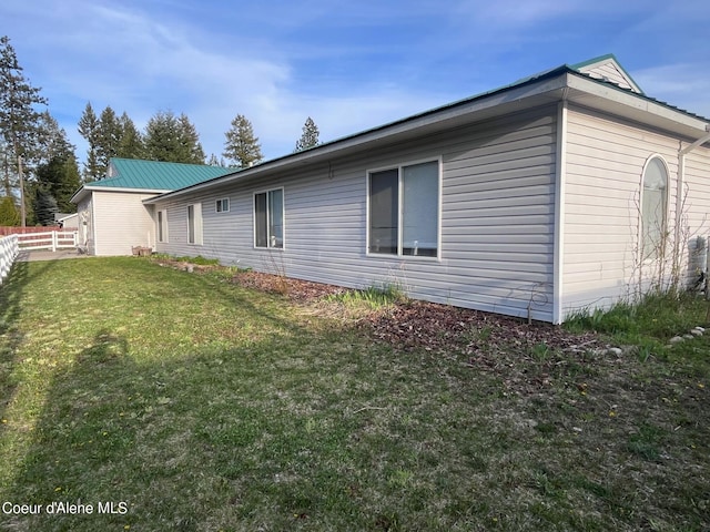 view of property exterior with a yard