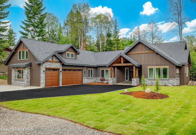 craftsman house with a front lawn and a garage