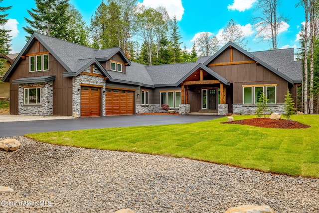 craftsman inspired home with a front yard and a garage