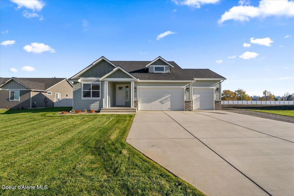 view of front of property with a garage and a front lawn