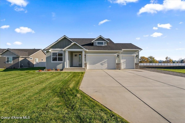 view of front of property with a garage and a front lawn