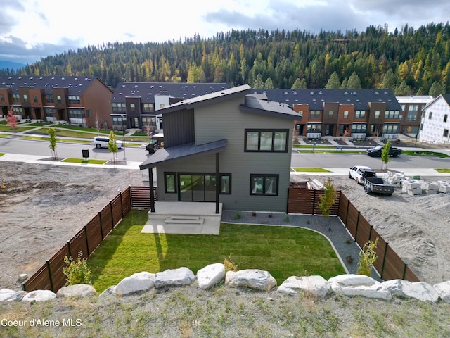 rear view of house featuring a lawn