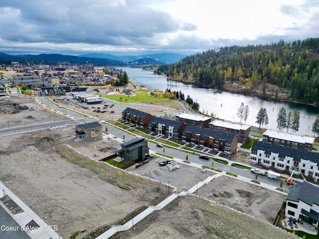 drone / aerial view featuring a water and mountain view