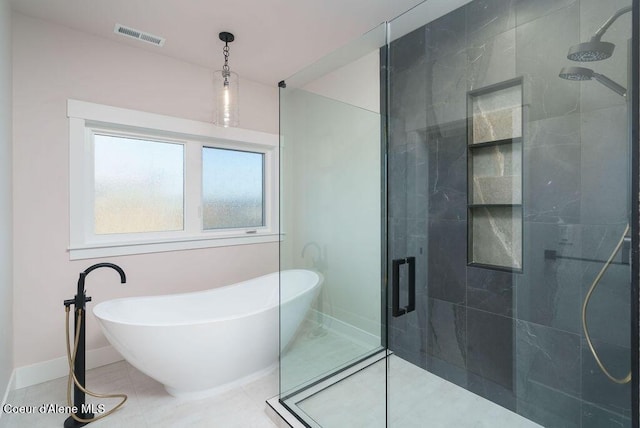 bathroom featuring shower with separate bathtub and tile patterned flooring