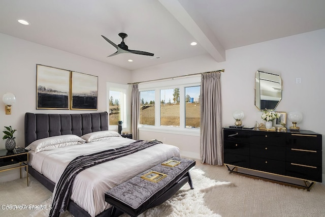 bedroom with beamed ceiling, light carpet, and ceiling fan