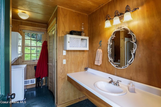 1930 Warren Island Shrs, Hope, ID 83836 - bathroom featuring a sink, stacked washer / drying machine, wooden walls, and wooden ceiling