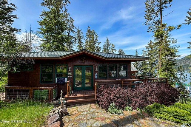 1930 Warren Island Shrs, Hope, ID 83836 - view of front of house with french doors, metal roof, and a deck