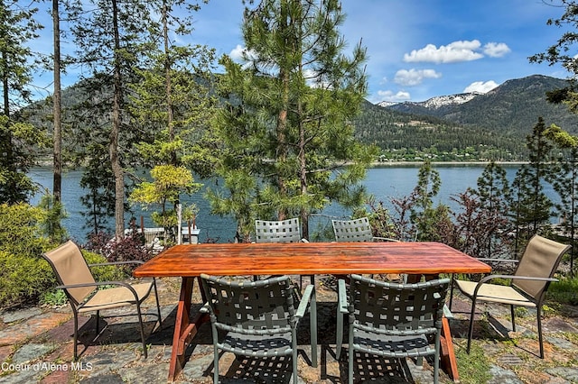 1930 Warren Island Shrs, Hope, ID 83836 - view of patio with outdoor dining area, a water and mountain view, and a view of trees