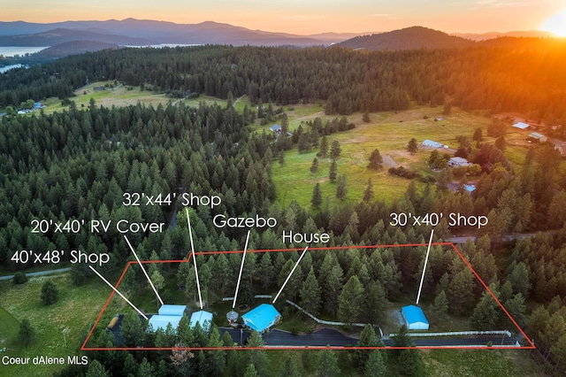 5718 E Sleepy Ln, Coeur Dalene, ID 83814 - aerial view at dusk of a view of trees, a mountain view, and property boundaries highlighted
