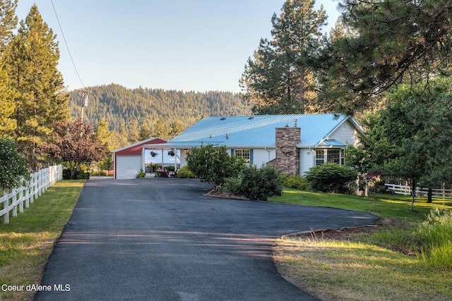 5718 E Sleepy Ln, Coeur Dalene, ID 83814 - ranch-style home with a garage, a metal roof, and driveway