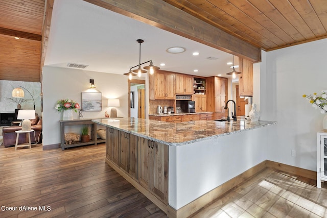 5718 E Sleepy Ln, Coeur Dalene, ID 83814 - kitchen with open shelves, a wooden ceiling with exposed beams, wood-type flooring, light stone countertops, and a peninsula