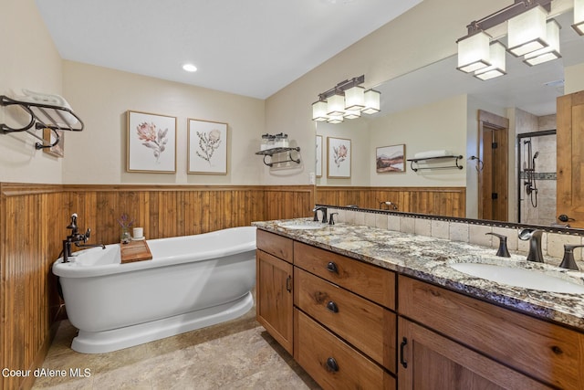 5718 E Sleepy Ln, Coeur Dalene, ID 83814 - full bath with a stall shower, double vanity, a freestanding tub, and a wainscoted wall
