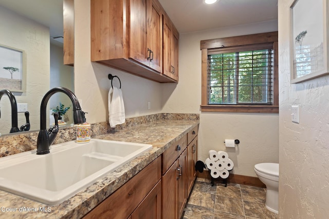 5718 E Sleepy Ln, Coeur Dalene, ID 83814 - kitchen with brown cabinets and stone finish flooring