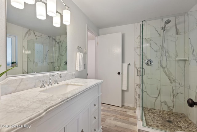5718 E Sleepy Ln, Coeur Dalene, ID 83814 - full bathroom featuring wood finished floors, vanity, and a marble finish shower