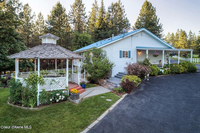 exterior space featuring a porch and a front lawn