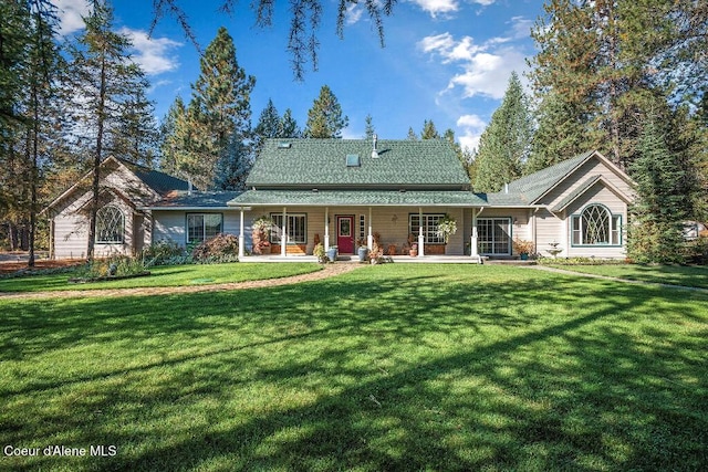 back of house featuring covered porch and a lawn