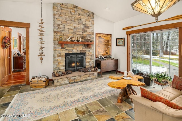 living room featuring lofted ceiling and a stone fireplace