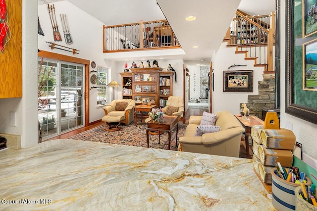 living area featuring a towering ceiling