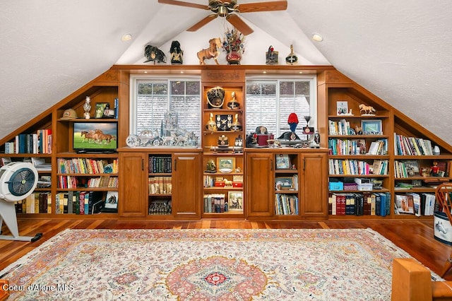 interior space featuring ceiling fan, plenty of natural light, hardwood / wood-style flooring, and vaulted ceiling