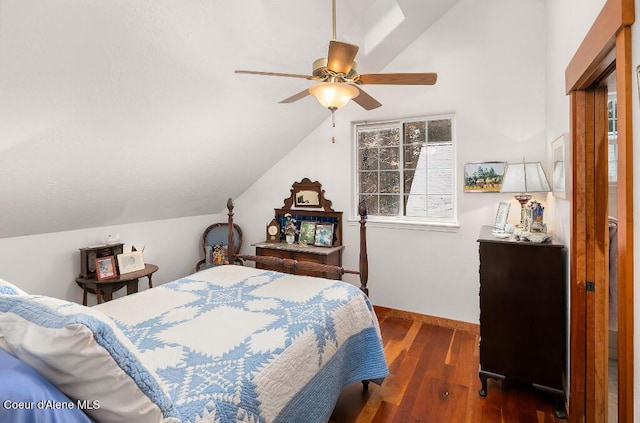 bedroom featuring ceiling fan, dark hardwood / wood-style flooring, and vaulted ceiling