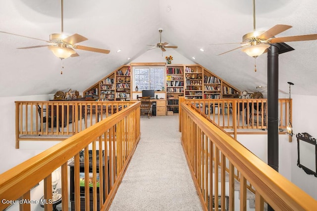 hallway with vaulted ceiling and light carpet