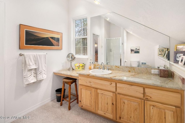 bathroom featuring toilet, vaulted ceiling, a shower with shower door, and vanity