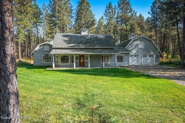 view of front of house featuring a front lawn, a porch, and an outdoor structure