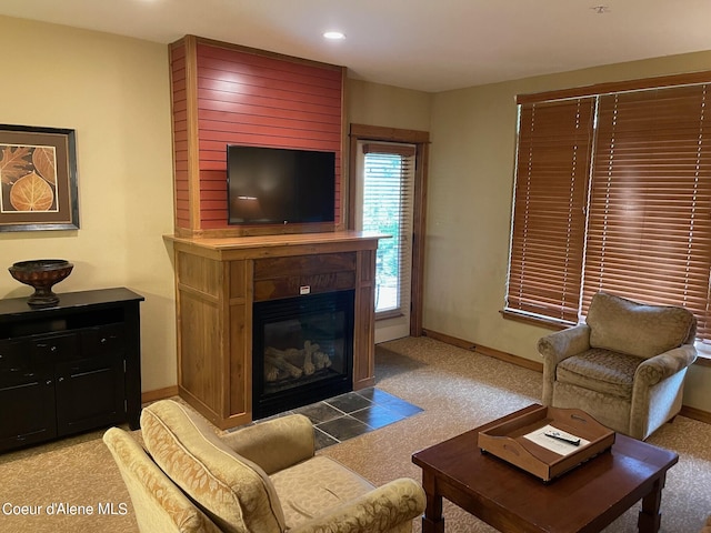 carpeted living room featuring wood walls