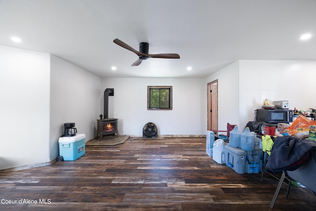 interior space featuring ceiling fan, wood finished floors, a wood stove, and recessed lighting