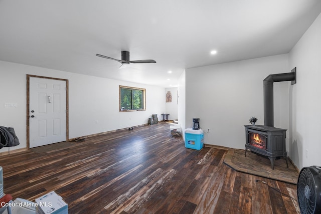 living area featuring ceiling fan, wood finished floors, a wood stove, and recessed lighting