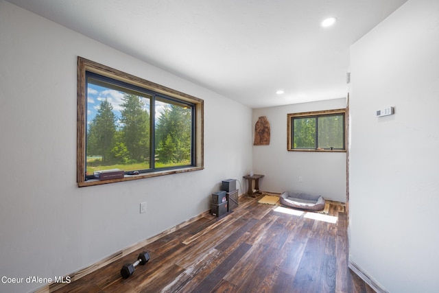 empty room with wood finished floors and recessed lighting