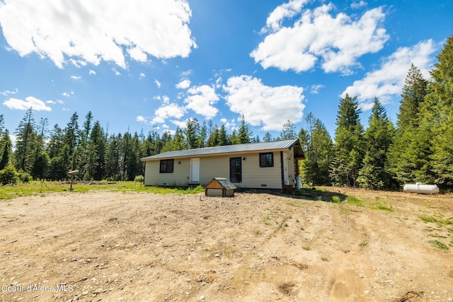 view of front facade with metal roof and crawl space