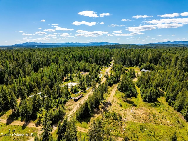 aerial view featuring a forest view and a mountain view