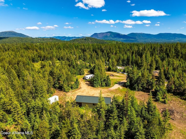 drone / aerial view with a mountain view and a wooded view