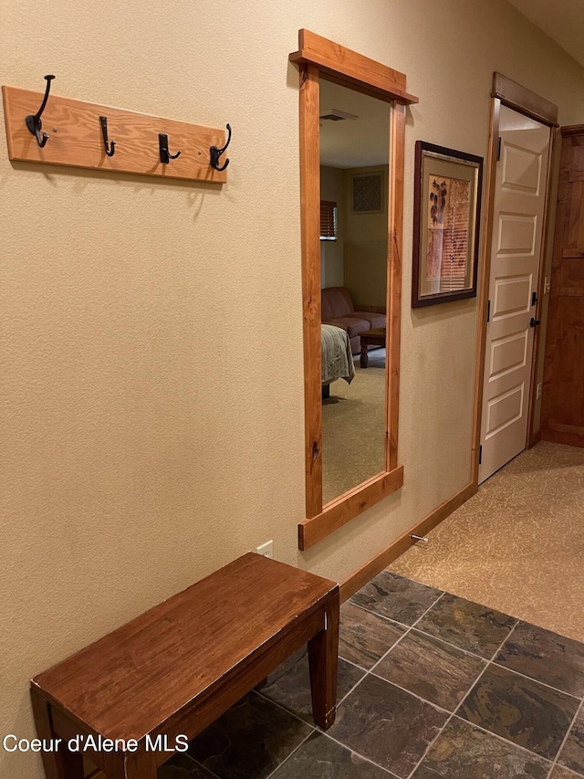 mudroom with dark carpet