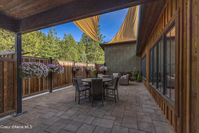 view of patio with outdoor dining area and a fenced backyard