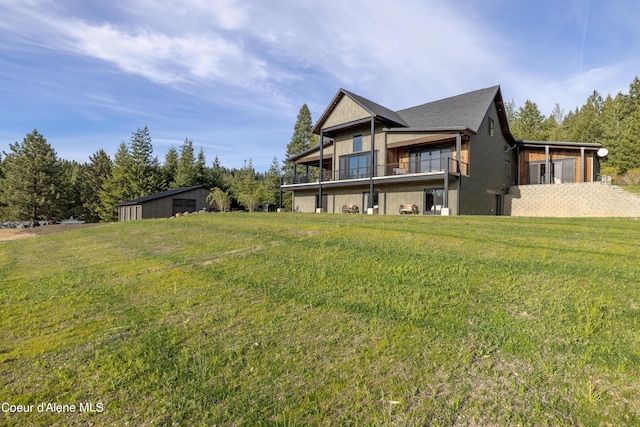 back of property with an outbuilding, a lawn, and a storage shed