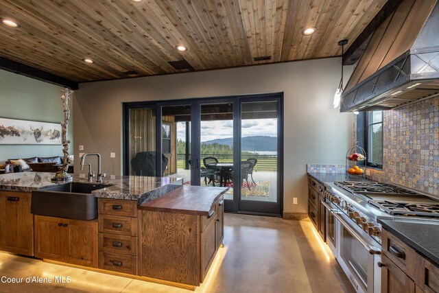 kitchen featuring range with two ovens, custom exhaust hood, decorative backsplash, wood ceiling, and a sink