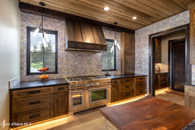 kitchen with dark countertops, custom exhaust hood, and range with two ovens