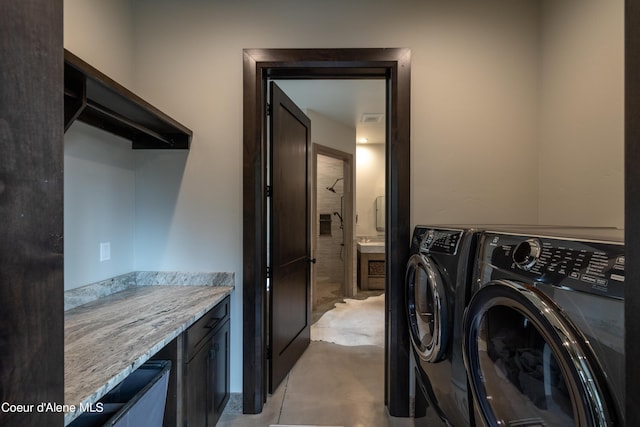 clothes washing area with washer / dryer