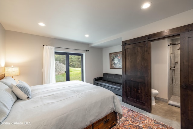 bedroom featuring ensuite bath, a barn door, and recessed lighting