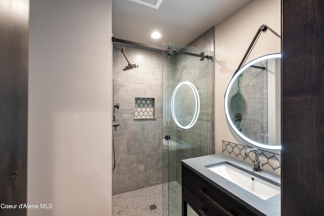 bathroom featuring recessed lighting, a shower stall, and vanity