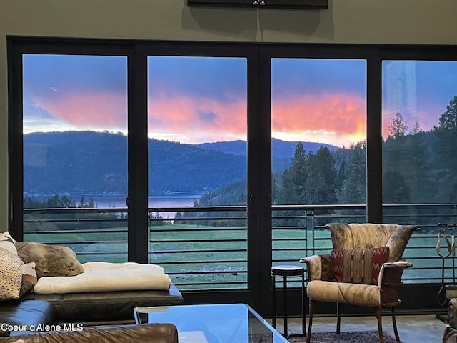 bedroom featuring a water and mountain view