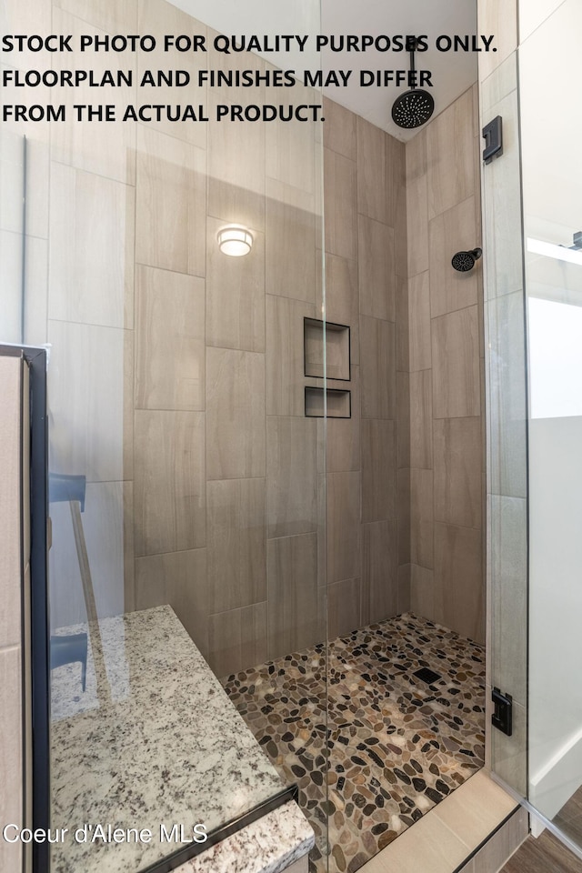 bathroom featuring a shower with door