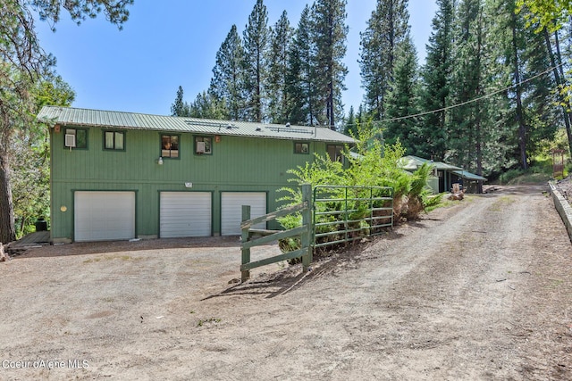 back of property with a garage