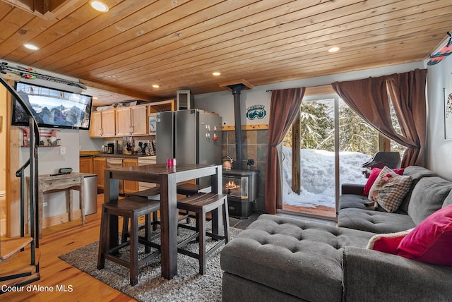 interior space with wood-type flooring, a wood stove, and wood ceiling