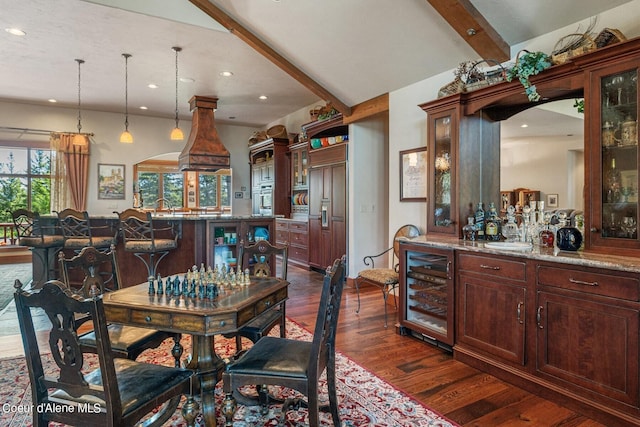 dining space with arched walkways, wine cooler, beam ceiling, recessed lighting, and dark wood-type flooring