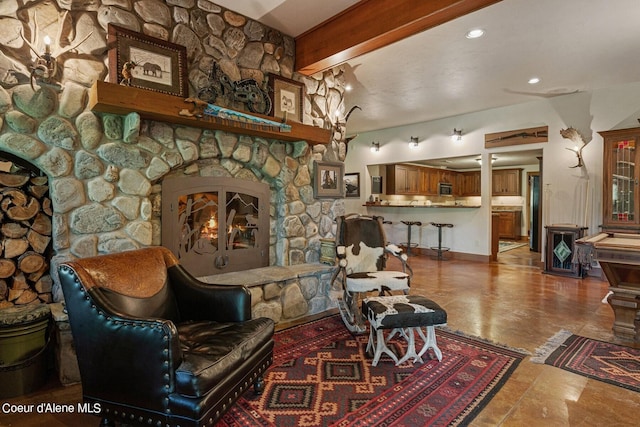sitting room with recessed lighting and a stone fireplace